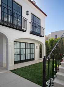 фрагмент фасада с большими окнами и коваными ограждениями цвета темный графит