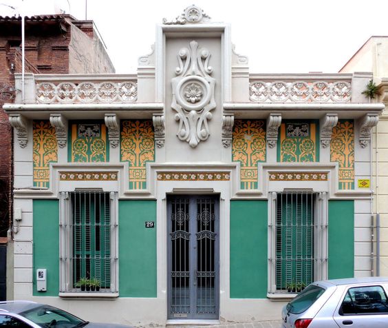 фото небольшого одноэтажного здания стиля модерн - штукатурный зеленый фасад с растительным орнаментом светло-персикового цвета